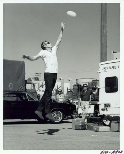 Steve McQueen playing football on the set.